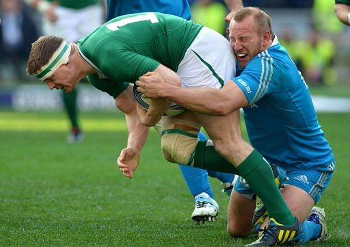 Ireland's centre Brian O'Driscoll (L) is tackled by Italy's hooker Leonardo Ghiraldini in Rome on March 16, 2013